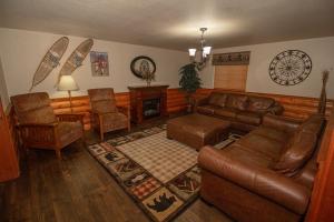 sala de estar con muebles de cuero y chimenea en FairBridge Inn and Suites Sandpoint, en Ponderay