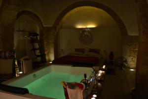 a bathroom with a tub in a room with a bed at AL TEMPO SOSPESO in Gioia del Colle