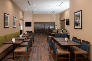 a dining room with wooden tables and chairs at Comfort Suites Cedar Park - Austin Northwest in Cedar Park