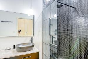 a bathroom with a sink and a glass shower at Le Franklin Roosevelt in Marseille +11 photos