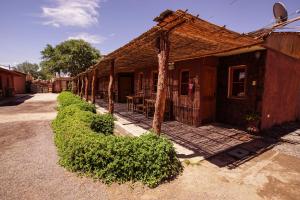 a building with a table and chairs outside of it at Casa Lickana B&B in San Pedro de Atacama