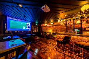 a bar with a large screen tv in a room at The Old Quarter Townhouse in Limerick