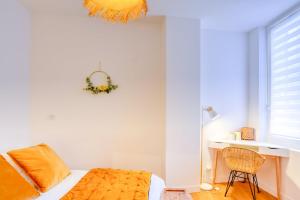 a bedroom with a bed and a desk and a window at Le Franklin Roosevelt in Marseille