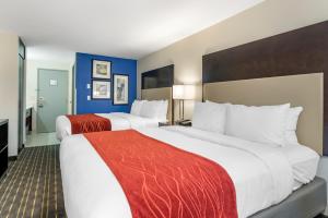 two beds in a hotel room with blue walls at Comfort Inn & Suites Tigard near Washington Square in Tigard