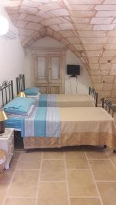 Postel nebo postele na pokoji v ubytování Palazzo Mellacqua