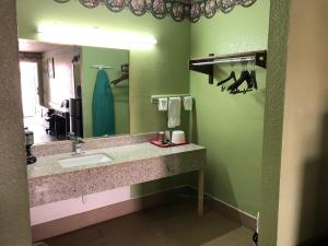 a bathroom with a sink and a mirror at Lone Star Inn in Cisco