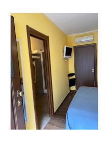 a bedroom with a bed and a door to a bathroom at Alloggio turistico in Capodimonte
