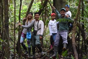 a group of people standing in the woods at Lodge Jungle Wolf Expeditions in Yucuruche