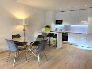 cocina y comedor con mesa y sillas en New!! Luxury Avenida Da Liberdade Flat- with Rooftop and Pool, en Lisboa