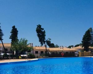 a large blue swimming pool in front of some buildings at Mirador del Lago in Córdoba