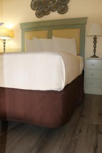 a large bed with white sheets and pillows at The Prytania Park Hotel in New Orleans