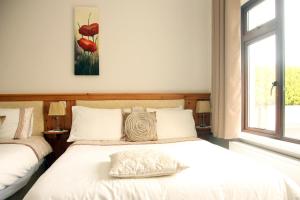 a bedroom with two beds and a window at Torine House B&B in Killorglin