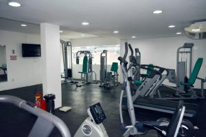 a gym with several tread machines in a room at Hotel Áster in Alagoinhas