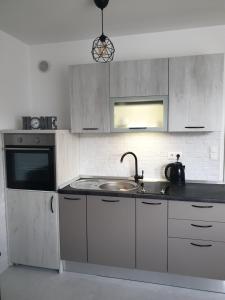 a kitchen with a sink and a counter top at Apartman Viktoria in Tuzla