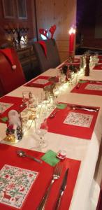 a long table with red napkins and glasses on it at Chalet TERRA LOUP in Le Dévoluy +7 photos