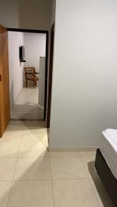 a view of a room with a bed and a table at Loft Pireneus 1 in Pirenópolis +15 photos