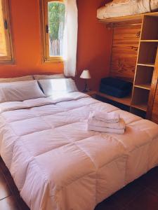 a bed with two towels on it in a bedroom at Terrazas de Uspallata in Uspallata
