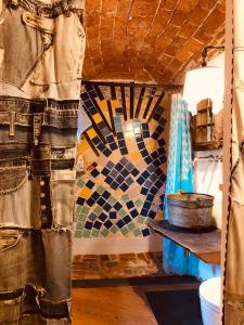 a room with a mosaic wall and a table with a pot at Bed and breakfast Ca du 5 in Tovo San Giacomo +65 photos