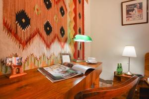 a desk with a lamp and a book on it at Mieszkanko koło Zamku in Warsaw