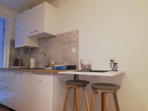 a kitchen with two bar stools and a counter at Studio Apartment New Home in Zagreb