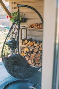 a hanging basket filled with fire logs on a porch at Leśna Przystań in Sasino