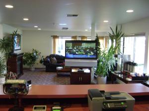 a living room with a large screen tv in a living room at Edgewick Inn in North Bend