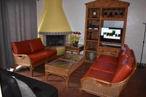 a living room with a couch and a tv at La Paloma Beach&Tennis Resort in Rosarito