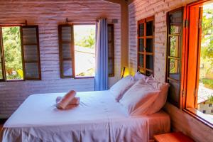 Ένα ή περισσότερα κρεβάτια σε δωμάτιο στο Vila do Sossego