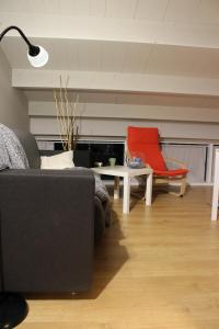 a living room with a couch and a red chair at Otium in Giulianova