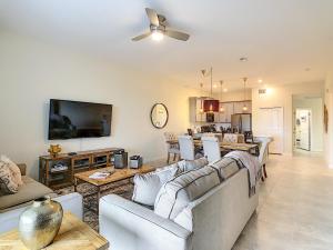 a living room with couches and a dining room at Gorgeous 2BR with Waterpark & 2 Clubhouses in Kissimmee