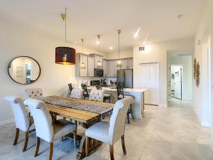 a kitchen and dining room with a table and chairs at Gorgeous 2BR with Waterpark & 2 Clubhouses in Kissimmee