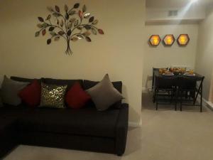 a living room with a couch and a dining table at Airdrie Apartments in Airdrie