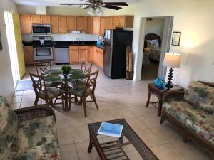 a kitchen and living room with a table and chairs at Addy's Villas in Venice