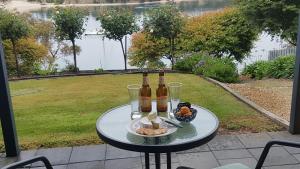 a table with beer bottles and a bowl of fruit at Lewi Waters in Lewisham