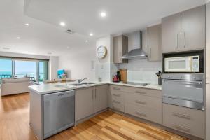 a kitchen with stainless steel appliances and a microwave at Sea Star - Aldinga Beach - C21 SouthCoast Holidays in Aldinga Beach
