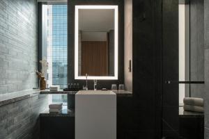 a bathroom with a sink and a mirror at The Clan Hotel Singapore by Far East Hospitality in Singapore