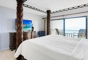 een slaapkamer met een bed en uitzicht op de oceaan bij Canaveral Towers 401 in Cape Canaveral +244 foto's
