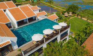 an aerial view of a villa with a swimming pool at Legacy Hoi An Resort in Hoi An