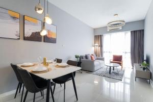 a dining room and living room with a table and chairs at Madam Design 2 at Kota Damansara in Petaling Jaya