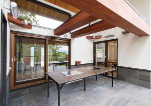 a dining room with a table and a balcony at NISEKO REISE HOUSE ニセコライゼハウス in Kutchan