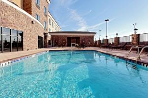 a large swimming pool in front of a building at Holiday Inn Express Hotel and Suites - Odessa, an IHG Hotel in Odessa