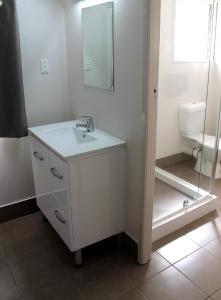 La salle de bains blanche est pourvue d'un lavabo et de toilettes. dans l'établissement Motel 707, à Emerald