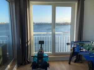 a room with a large window with a view of the water at Schleivilla Hafenmeister in Kappeln