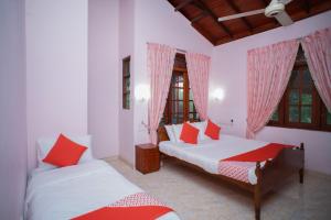 a bedroom with two beds and two windows at Madoldu eco resort in Koggala +72 photos