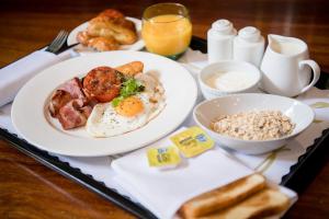 a tray of breakfast food with eggs and bread on a table at Pagoda Resort & Spa in Perth