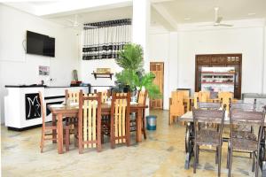 a dining room with a table and chairs at Mallika Resort in Trincomalee