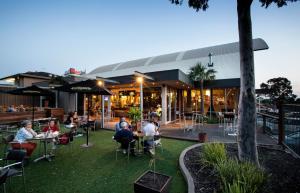 a group of people sitting outside of a restaurant at Nightcap at Shoppingtown Hotel in Doncaster