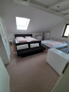 a bedroom with three beds in a room with a window at Ferienwohnung Memil in Immenstadt im Allgäu