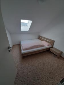 a small bedroom with a bed and a window at Ferienwohnung Memil in Immenstadt im Allgäu