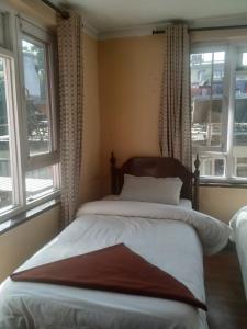 Ένα ή περισσότερα κρεβάτια σε δωμάτιο στο Beehive Hostel Kathmandu